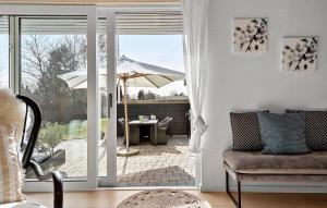 an open door to a patio with an umbrella at Nice Home In Græsted With Wifi in Græsted