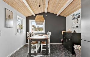 a dining room with a table and chairs at Nice Home In Græsted With Wifi in Græsted