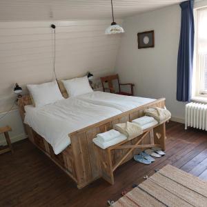 a bedroom with a large bed with white sheets at Bed&Breakfast ons Oda in Sint-Oedenrode