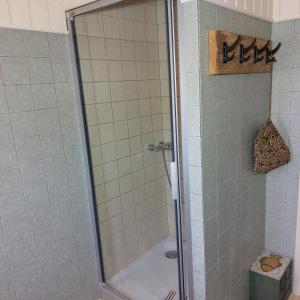 a shower with a glass door in a bathroom at Bed&Breakfast ons Oda in Sint-Oedenrode