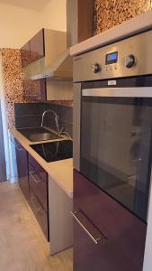 a kitchen with a stove and a sink at Chic Central Stay in Luxembourg in Luxembourg