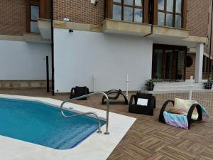 a swimming pool with a slide next to a building at Apartamentos Boutique Don Miguel in Noja