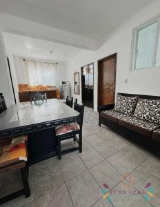 a living room with a couch and a table at Terrazas Hotel and Hostel in Taxco de Alarcón +87 photos