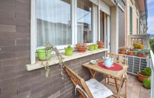 a patio with a table and chairs and a window at Stunning Apartment In Viareggio in Viareggio