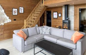 a living room with a couch and a fireplace at 4 Bedroom Lovely Home In Rysstad in Rysstad