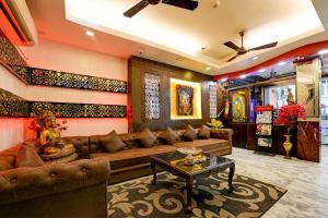 a living room with a couch and a table at Hotel Shiva Intercontinental -New Delhi Railway Station in New Delhi
