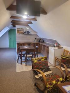 a kitchen with a table and chairs in a room at Ubytovanie na včelej farme in Polichno