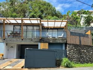 a house with a balcony with a fence at Villa DELTA in Sainte-Marie
