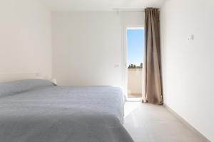 Postel nebo postele na pokoji v ubytování Terrazza dei Briganti by BarbarHouse