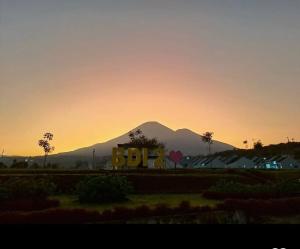 a mountain in the distance with a sign in the foreground at Compound Villa Wonosobo - 3 Bedrooms Tipe Dahlia in Wonosobo