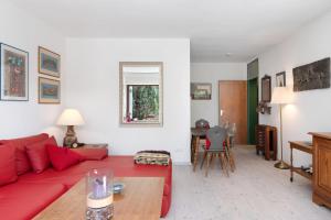 a living room with a red couch and a table at Ferienwohnung Victoria in Schonwald im Schwarzwald