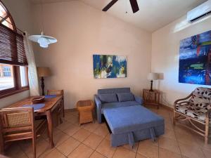 a living room with a couch and a table at Melrose Suite in San Juan del Sur
