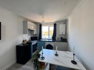 a kitchen with a table with two candles on it at Cosy Retreat in Greenwich