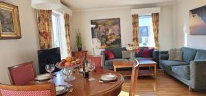 a living room with a table and a couch at Midt i byn in Bergen