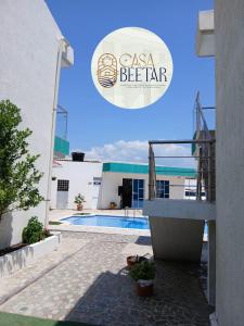 a villa with a swimming pool and a sign that says csa bear at Casa campestre en punta canoa Cartagena in Punta Canoas