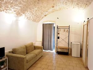 a living room with a couch and a window at Minuetto 73 in Ostuni +4 photos