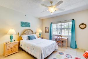a bedroom with a bed and a desk and a window at Waterfront Condo with Pool on Lake of the Ozarks in Lake Ozark +21 photos