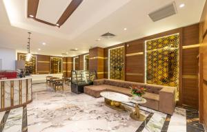 una sala de estar con un sofá y una mesa en The Western Hill Dalat Hotel, en Da Lat