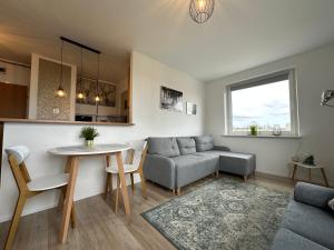 a living room with a couch and a table at Panorama Bałtyku in Sopot