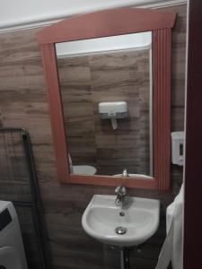a bathroom with a sink and a mirror at Alma Apartman 713 in Zalakaros +7 photos