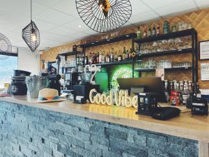 a bar at a restaurant with a counter with drinks at Beaujour & Bonsoir - Hotel in Villy-le-Pelloux