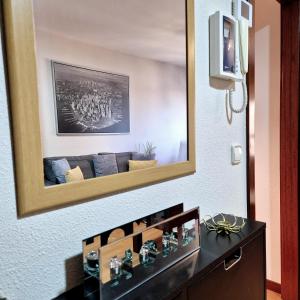 a mirror hanging on a wall above a dresser at VistasAragon in Vigo +53 photos