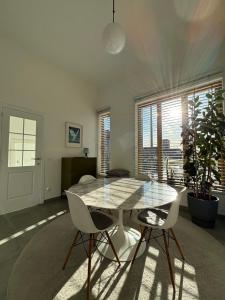 a dining room with a glass table and two chairs at Luxury apartment, private terrace & FREE PARKING in Antwerp