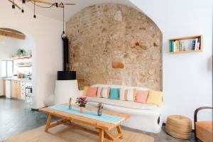 a living room with a couch and a table at HoMe Hotel Menorca in Ciutadella