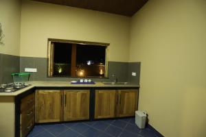 a kitchen with a sink and a window at AMcroos in Negombo