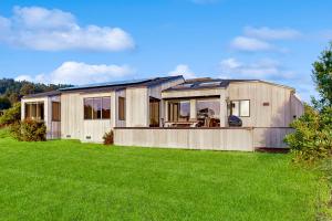 a large wooden house with a green lawn at Blue Heron in Sea Ranch