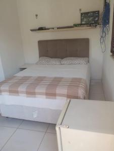 a bedroom with a bed and a table in it at Tabuleiro Beach in Aquiraz