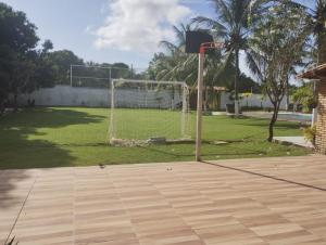 a basketball hoop with a goal in a park at Tabuleiro Beach in Aquiraz +6 photos