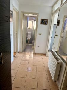 a hallway with a tile floor and a bathroom at Andjelka apartman in Modriča +7 photos