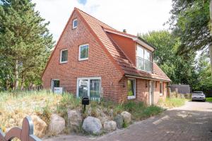 a red brick house with rocks in front of it at Ankerplatz SPO 2 in Böhl