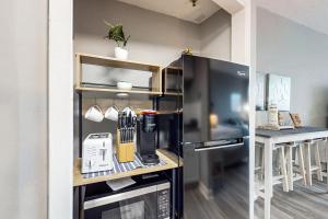 a kitchen with a refrigerator and a counter with utensils at Pirates Bay B315 - Bayfront Beauty in Fort Walton Beach