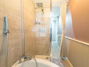 a bathroom with a shower and a sink and a tub at Basildon Retreat Cozy 3-Bedroom Home in Basildon