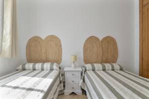 Łóżko lub łóżka w pokoju w obiekcie Apartamento Perez Zara 7