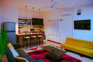 a living room with a couch and a kitchen at Top GrandiaHouse in Puerto Vallarta