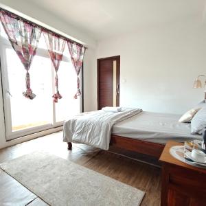 Postel nebo postele na pokoji v ubytování The Breeze Homestay