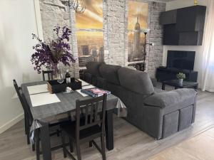 a living room with a couch and a dining room table at Apartamento Paula in Valladolid