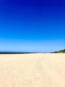 a sandy beach with a blue sky in the background at Apartamento a pie de playa en El Portil in El Portil