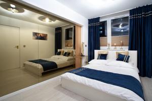 a bedroom with two beds and a mirror at Katowice Golden Peacock - Grazynskiego 7 in Katowice