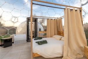 a bedroom with a bed and a tent at Folià Natural Experience in San Vito dei Normanni