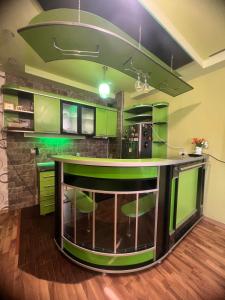 a kitchen with green cabinets and a green island at SWEET APARTMENT KUTaISI in Kutaisi