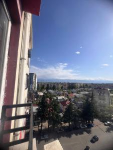 a view of a city from a window of a building at SWEET APARTMENT KUTaISI in Kutaisi