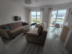 a living room with a couch and a table at Słoneczny Nadmorska in Grzybowo