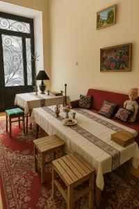 a living room with a red couch and a table at HeyTun Gyumri in Gyumri