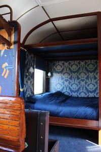 a bedroom with two bunk beds on a train at Bed and Breakfast Station Marrum-Westernijkerk in Marrum