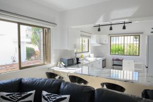 a living room with a couch and a kitchen at Cavo Greco Oasis in Protaras