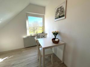a dining room with a table and a window at Ferienwohnung Dorfblick Kirchdorf in Kirchdorf +9 photos
